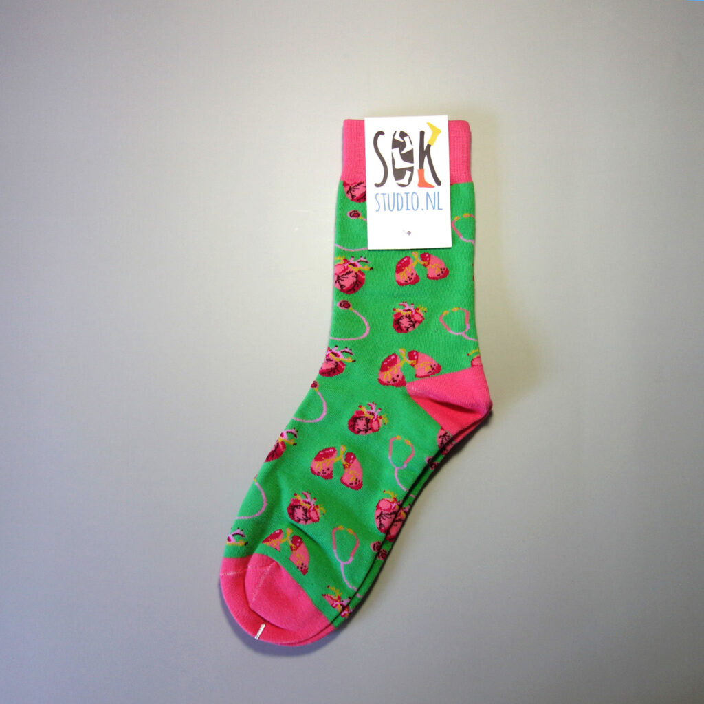 A custom made sock with "heart beating" patterns on it. The sock is attached with a custom made top tag with logo. Base color: Green. Secondary colors: red, pink.